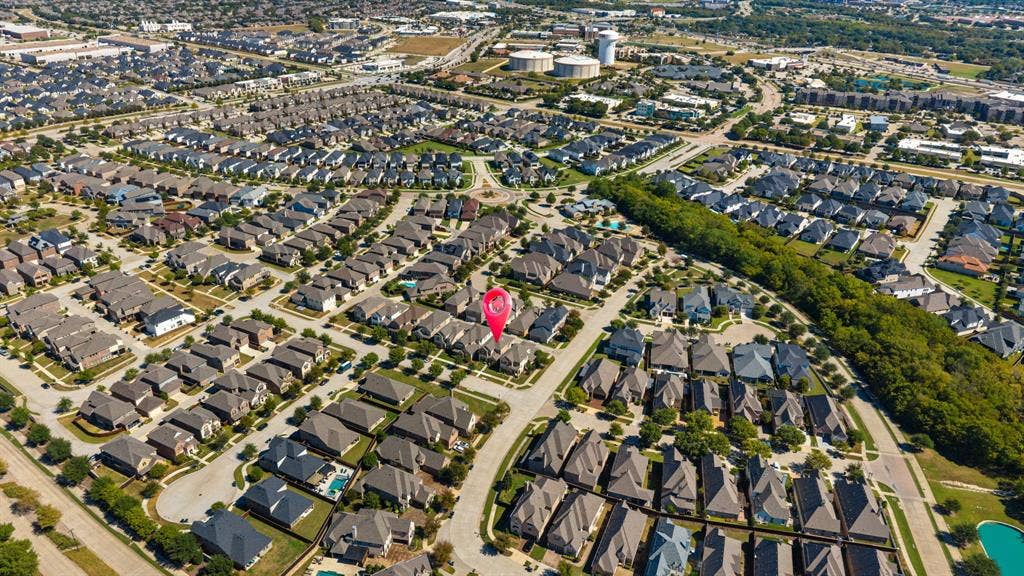 Aerial perspective of a developed residential area with numerous single-family homes and landscaped streets