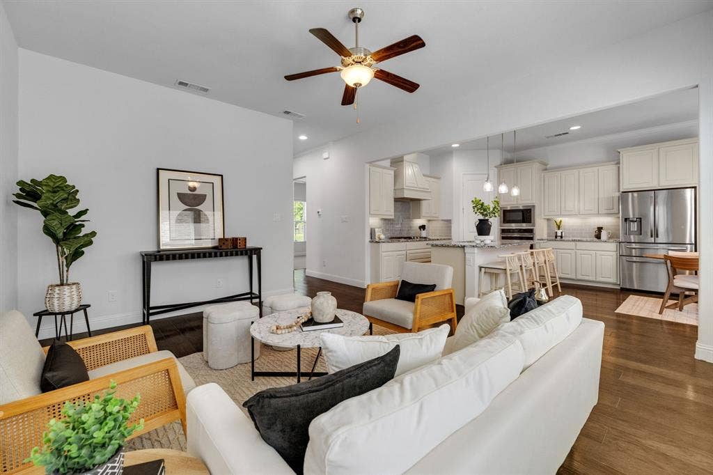 Open-concept living area featuring wood-finish flooring, recessed lighting, and a ceiling fan