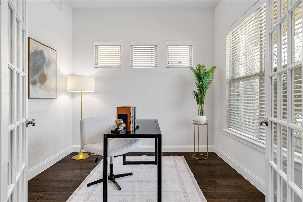 Front office- French doors with glass panes, dark wood-finish flooring, white walls, and multiple windows with blinds