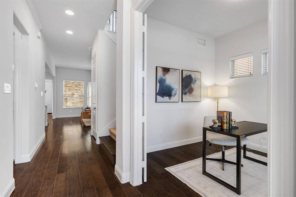 Wood-finish flooring throughout, recessed lighting, and white trim