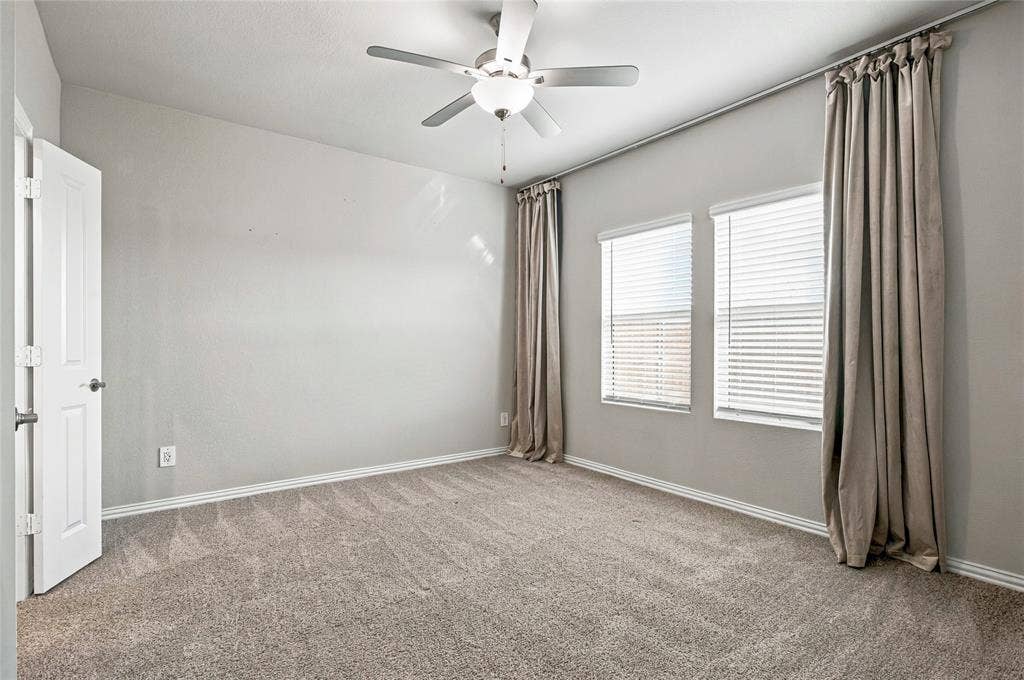 113 Greenbriar Drive, Princeton, TX 75071 Carpeted room with neutral walls, white trim, and a ceiling fan