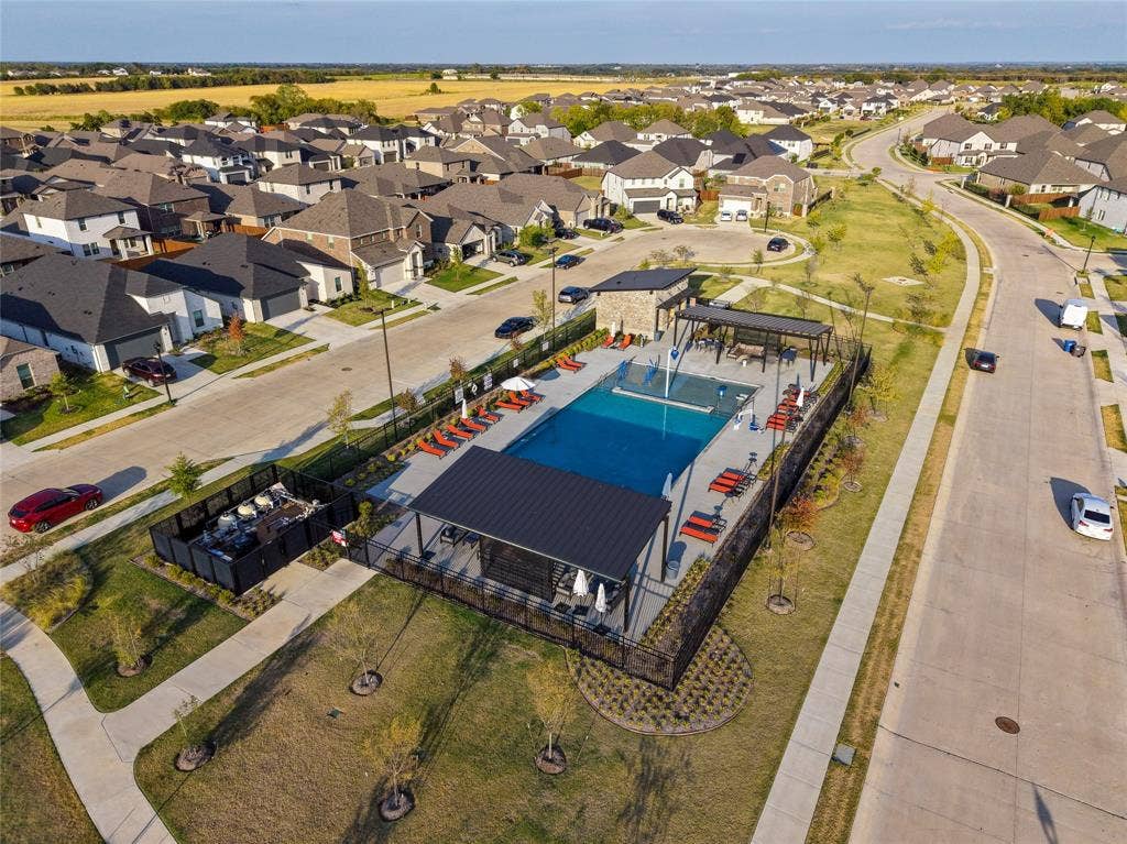 113 Greenbriar Drive, Princeton, TX 75071 Community swimming pool with an adjacent hot tub and shaded lounging areas