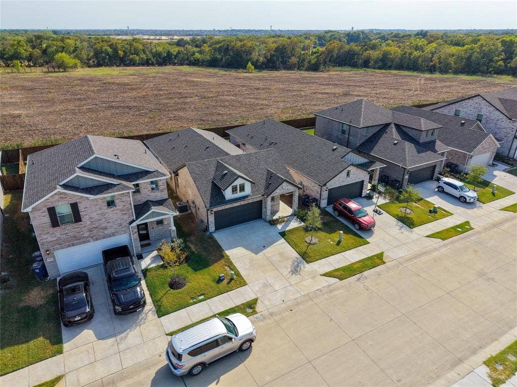 113 Greenbriar Drive, Princeton, TX 75071 Brick exterior with dark shingle roofing