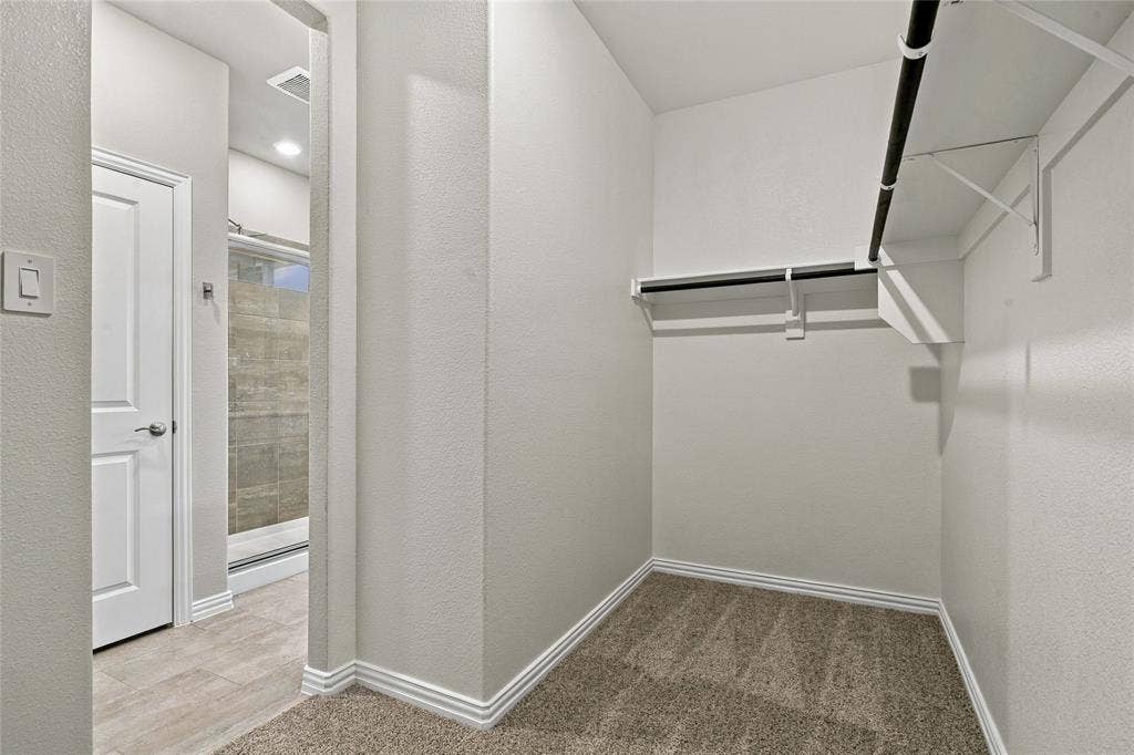 113 Greenbriar Drive, Princeton, TX 75071 Carpeted closet space with multiple hanging rods and shelving