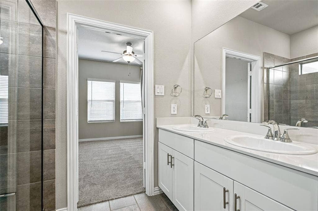 113 Greenbriar Drive, Princeton, TX 75071 Dual vanity with undermount sinks, white cabinetry, and brushed nickel hardware