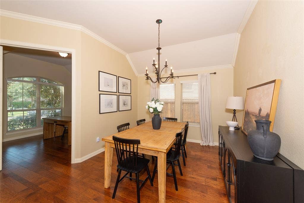 Wood-finish flooring throughout, vaulted ceiling, and crown molding