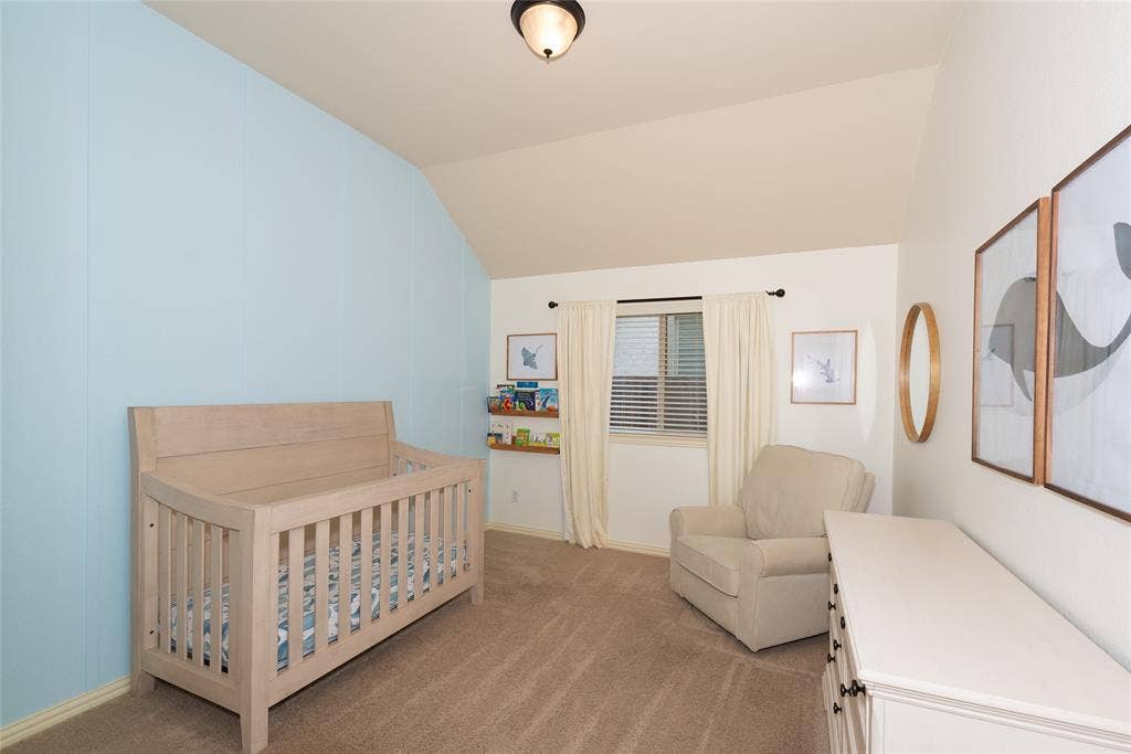 Sloped ceiling, recessed window, carpeted flooring, built-in shelving, and overhead lighting
