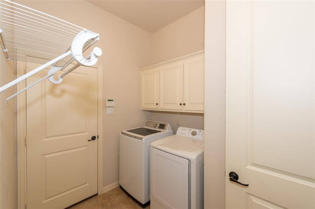 Built-in white cabinetry, light-toned walls, and a light-toned flooring