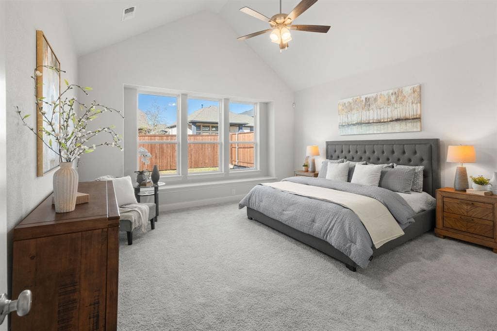 1320 Cartona Road, Fate, TX 75087 Vaulted ceiling, ceiling fan, carpeted flooring, three large windows, and a window seat
