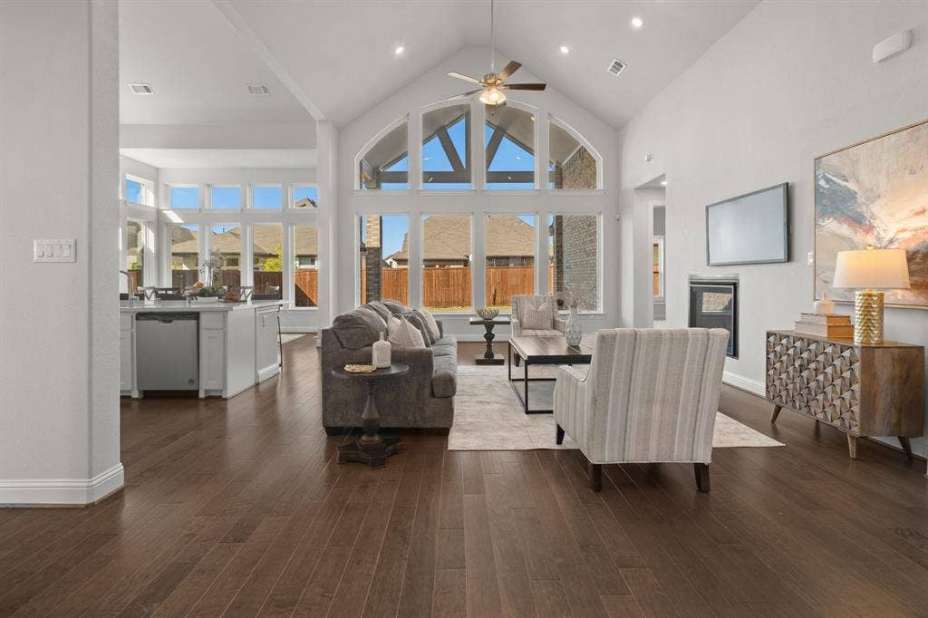 1320 Cartona Road, Fate, TX 75087 Vaulted Cathedral Style ceiling, Luxury vinyl wood-finish flooring, built-in fireplace, view of kitchen - quartz island and recessed lighting