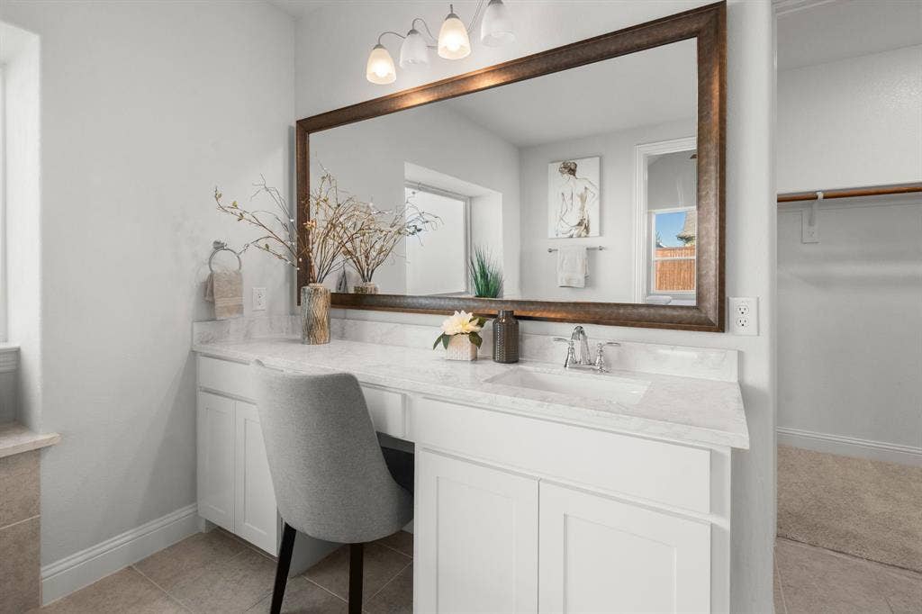 1320 Cartona Road, Fate, TX 75087 Bathroom vanity featuring a single basin sink, white cabinetry, and a light-toned countertop