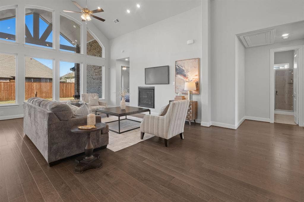 1320 Cartona Road, Fate, TX 75087 Vaulted Cathedral Style ceiling, Luxury vinyl wood-finish flooring, built-in fireplace, and recessed lighting