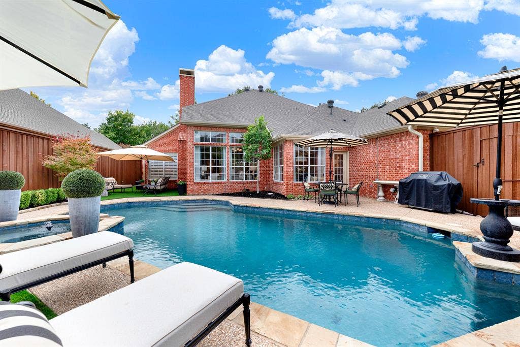 6429 GLENHOLLOW Drive, Plano, TX 75093 An expansive pea-gravel deck wraps around the pool, backed by a pool pump housing replaced in 2024 for worry-free operation. Unwind after work while listening to the tranquil spillover fountain into the main poo
