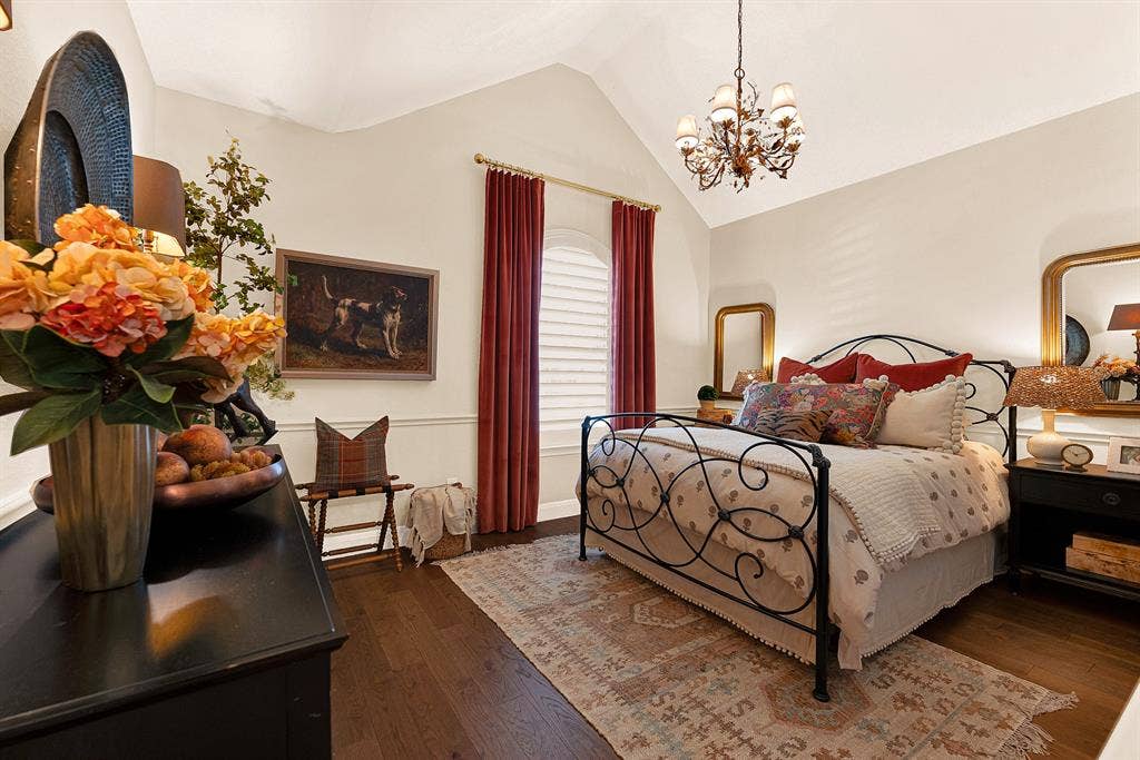 6429 GLENHOLLOW Drive, Plano, TX 75093 An elegant arched window and high pitch ceiling give this bedroom dramatic vertical scale illuminated by a classic chandelier. Enjoy cozy evening downtime surrounded by calm, inviting architectural character.