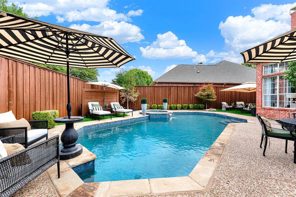 6429 GLENHOLLOW Drive, Plano, TX 75093 A privacy fence stained in 2026 encloses this private oasis around sparkling blue pool waters. Lounge comfortably poolside on warm sunny afternoons with a cool drink in hand.
