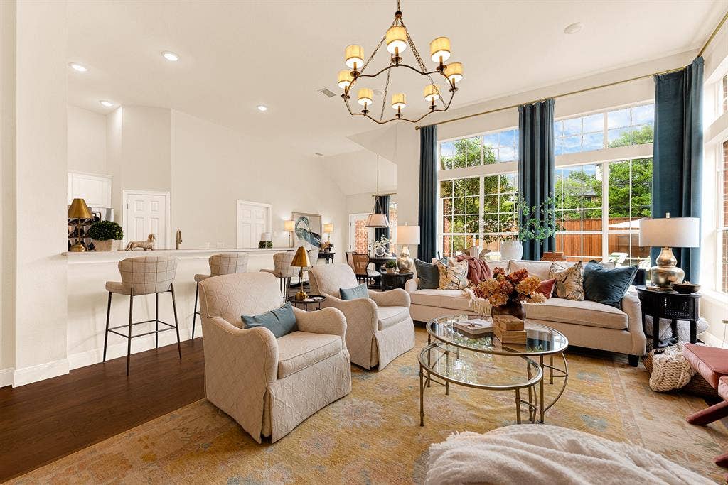 6429 GLENHOLLOW Drive, Plano, TX 75093 Soaring ceilings and expansive wall-to-wall windows frame vibrant outdoor views, flooding the space with bright midday light. Enjoy effortless weekend afternoons chatting with guests at the bar while keeping an eye on pool activities.