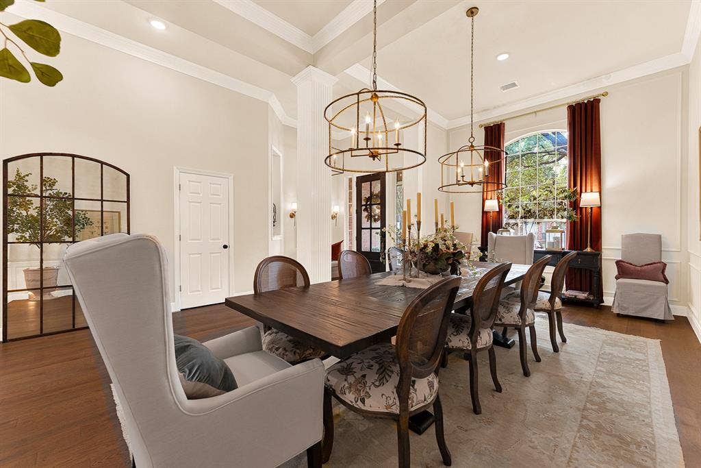 6429 GLENHOLLOW Drive, Plano, TX 75093 A grand arched window creates an elegant focal point, pouring warm sunlight across the detailed wall trim and high ceilings. Imagine lingering over Sunday brunch with family while enjoying peaceful morning garden views.