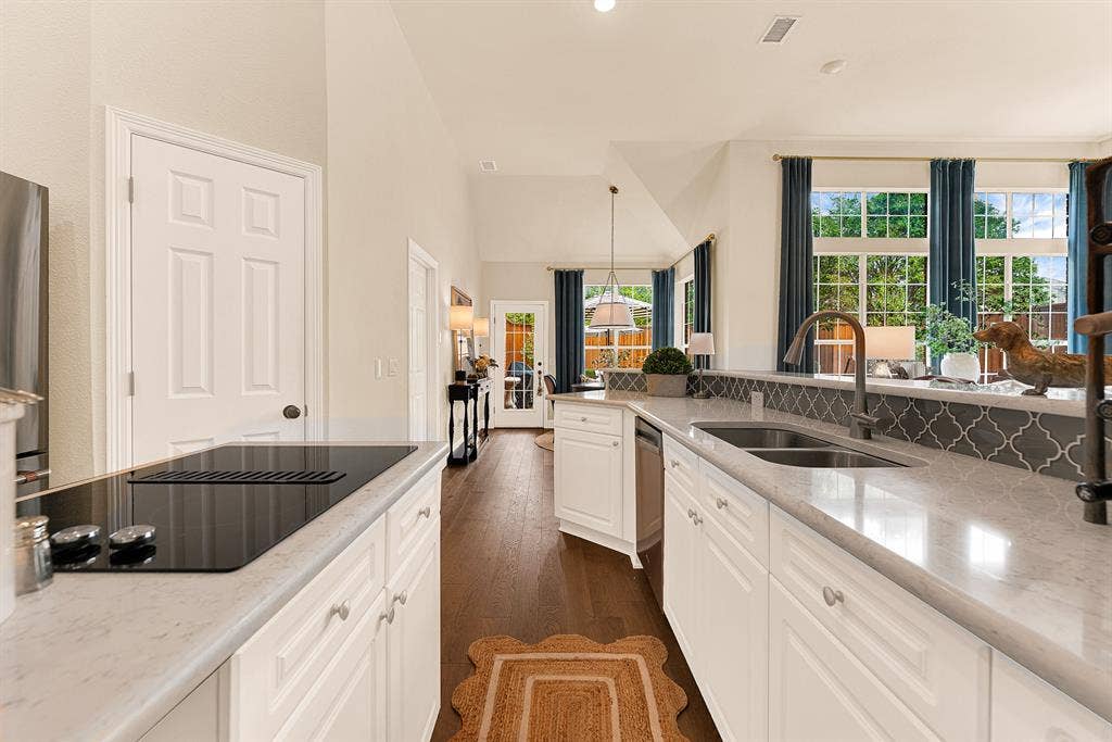 6429 GLENHOLLOW Drive, Plano, TX 75093 An elongated breakfast bar overlooks the main living room, maintaining open sightlines and effortless connection across spaces. Serve casual morning breakfasts or evening appetizers to guests gathered right at the counter.