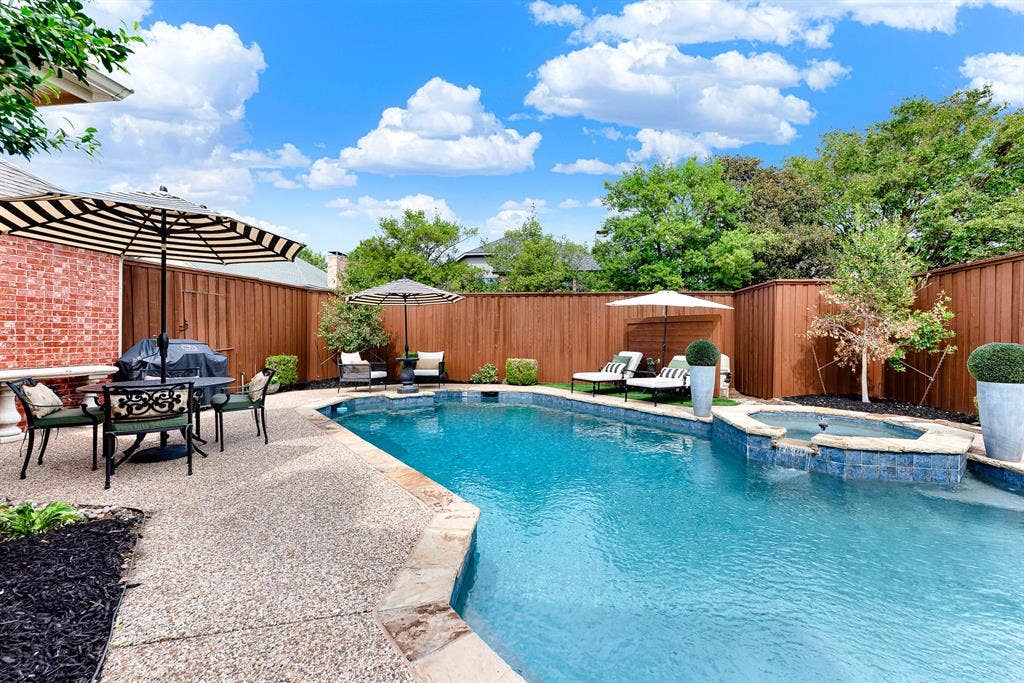 6429 GLENHOLLOW Drive, Plano, TX 75093 A spillover spa sits elevated above crystal-clear waters, serving as the focal point of the resort-style layout. Soak under stars in warm bubbling waters during quiet weekend evening retreats