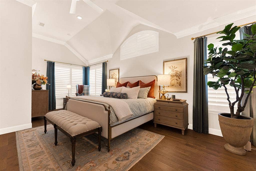 6429 GLENHOLLOW Drive, Plano, TX 75093 A sunlit sitting area in primary bedroom with views of backyard and pool captures bright natural light through shuttered windows. Savor a quiet morning coffee while taking in serene poolside vistas