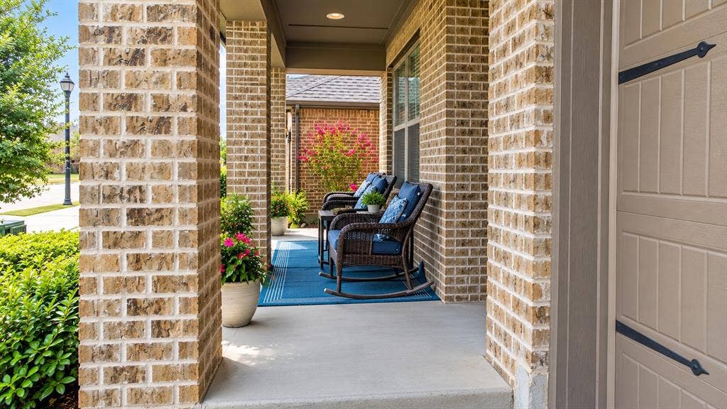 5617 Southern Fern Road, Garland, TX 75043 Brick exterior, covered concrete porch, decorative garage door, mature landscaping