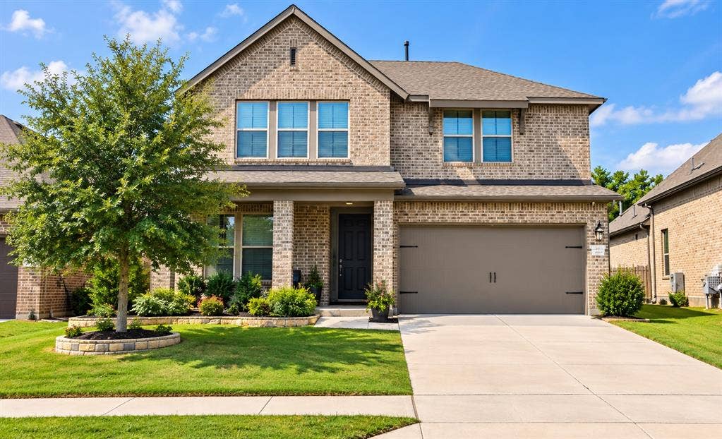 5617 Southern Fern Road, Garland, TX 75043 Brick exterior with a covered front entrance and a two-car garage