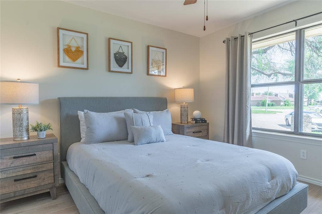 1011 Wimbledon Lane, Plano, TX 75075 Recessed window with natural light, wood-finish flooring, ceiling fan, and upholstered bed frame