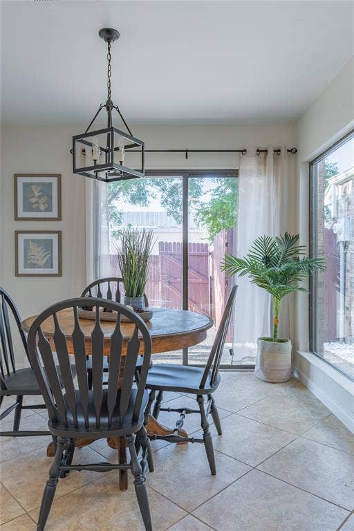 1011 Wimbledon Lane, Plano, TX 75075 Tile flooring, sliding glass door, large window, and a built-in light fixture