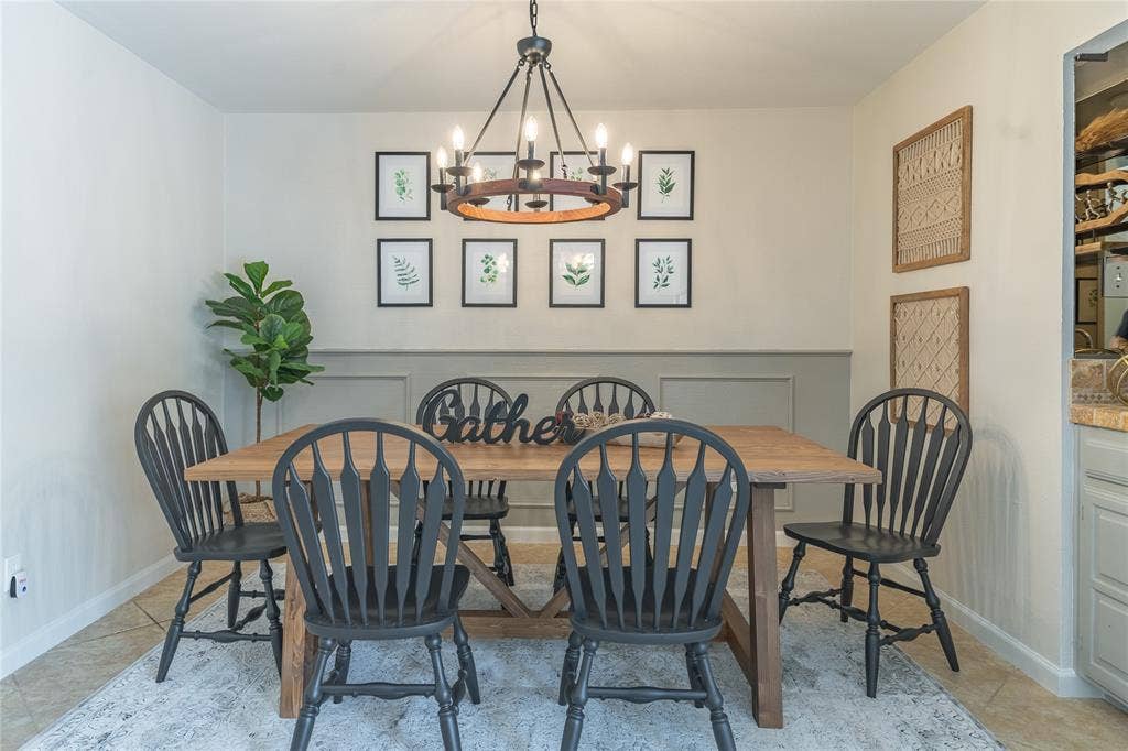1011 Wimbledon Lane, Plano, TX 75075 Wainscoting paneling, tile flooring, and an overhead chandelier with a circular wood-tone accent