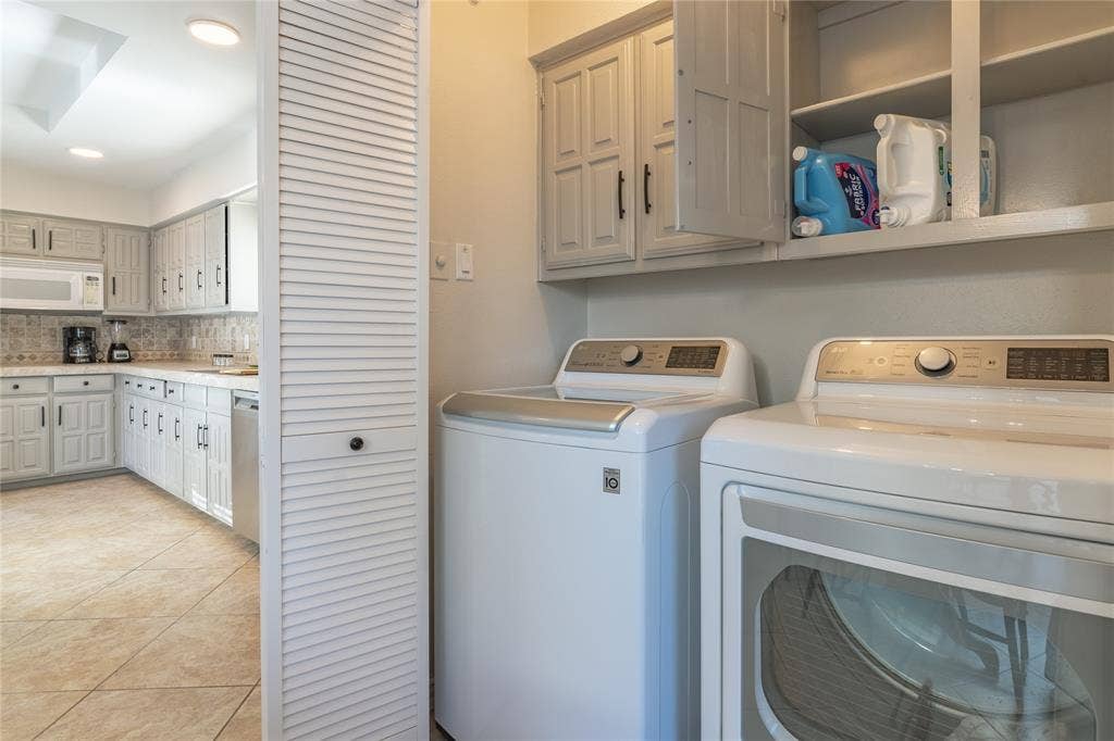 1011 Wimbledon Lane, Plano, TX 75075 Laundry area featuring upper cabinetry and shelving