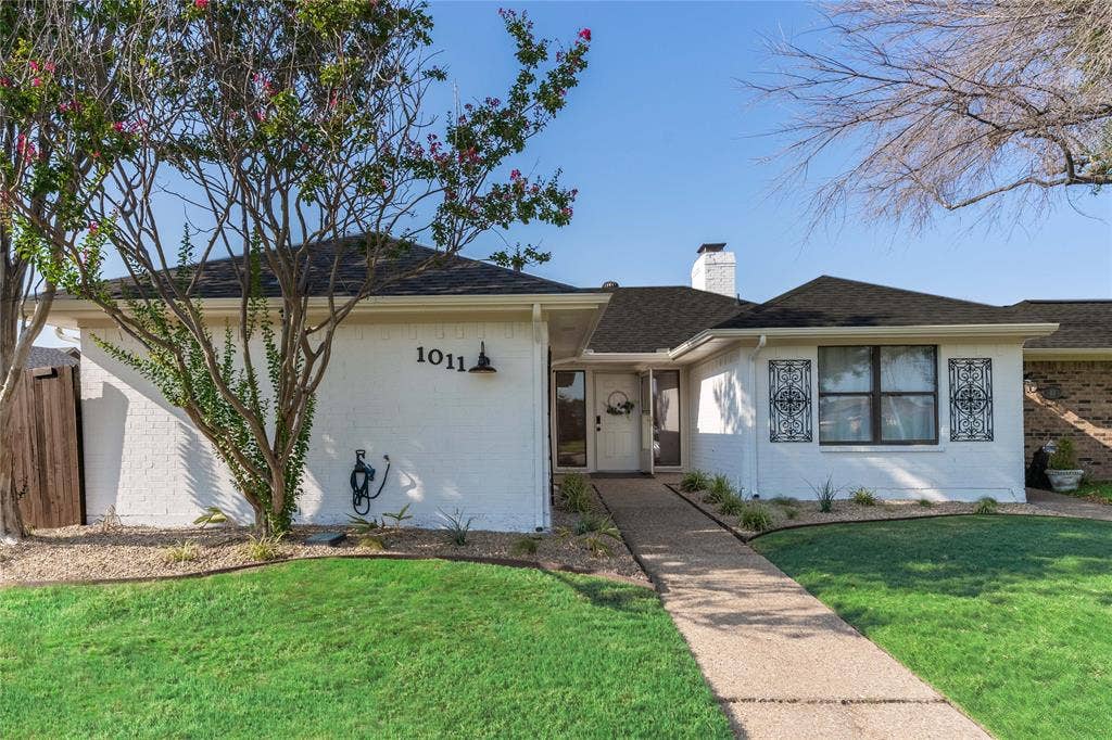 1011 Wimbledon Lane, Plano, TX 75075 White brick exterior with a dark shingle roof