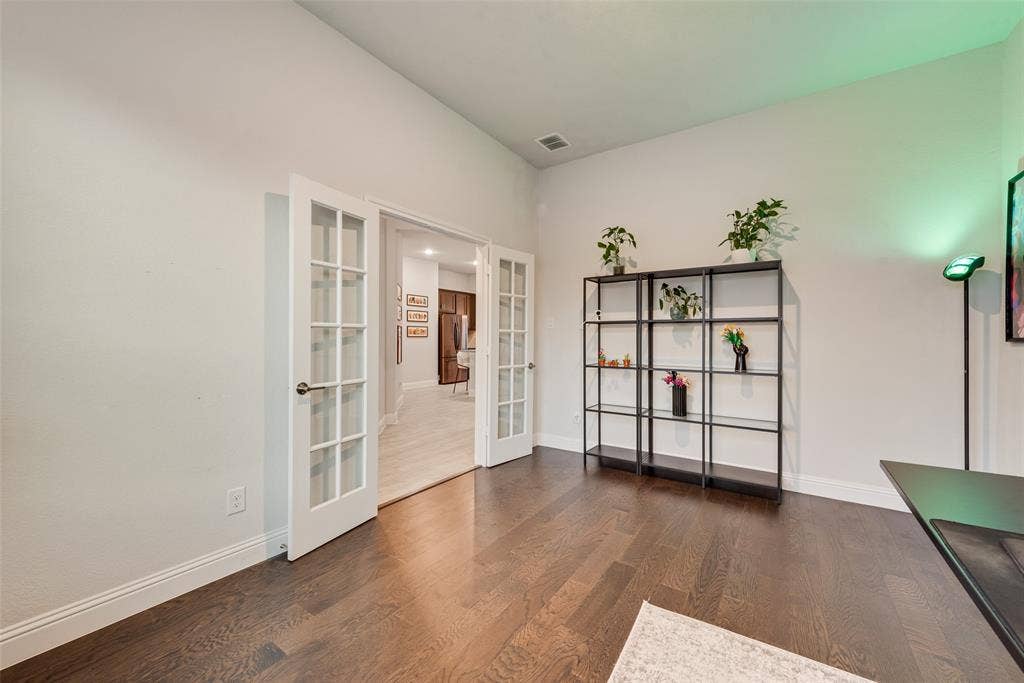 812 Stamford Avenue, Arlington, TX 76002 French doors with glass lites, wood-finish flooring, white walls, and recessed lighting
