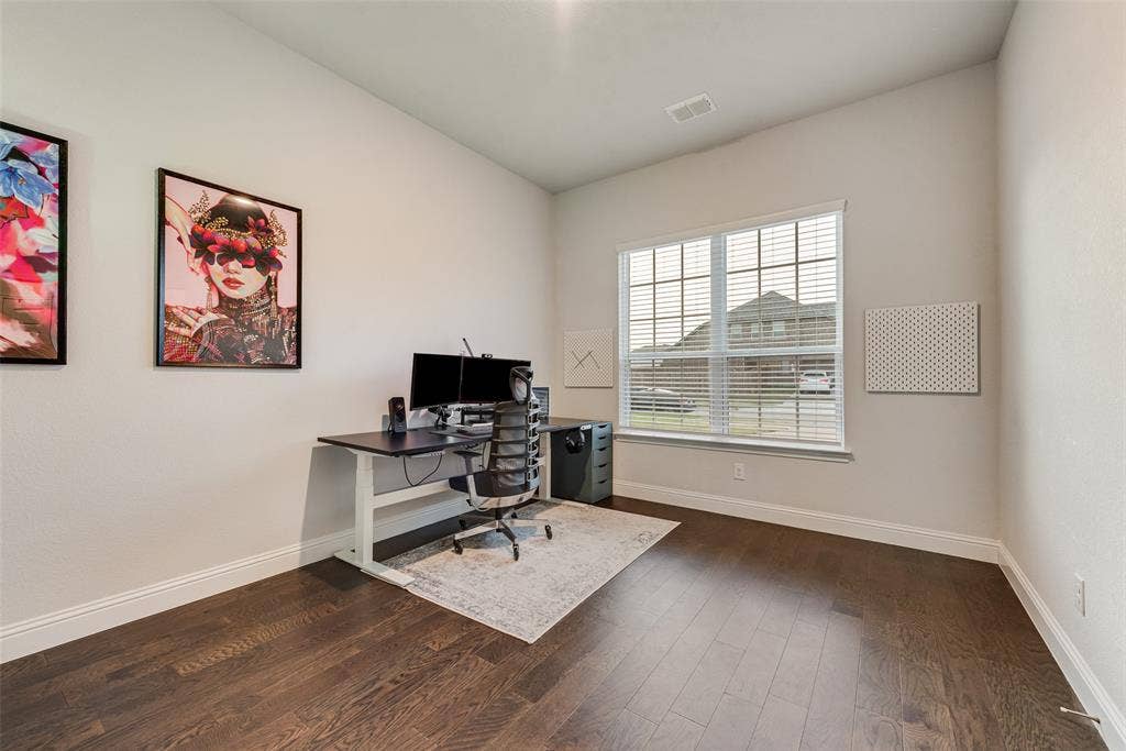 812 Stamford Avenue, Arlington, TX 76002 Spacious Office featuring wood-finish flooring, a large window with blinds, and white trim
