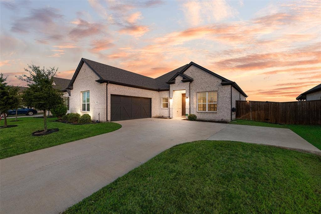 812 Stamford Avenue, Arlington, TX 76002 White brick exterior with dark trim and a gabled roofline