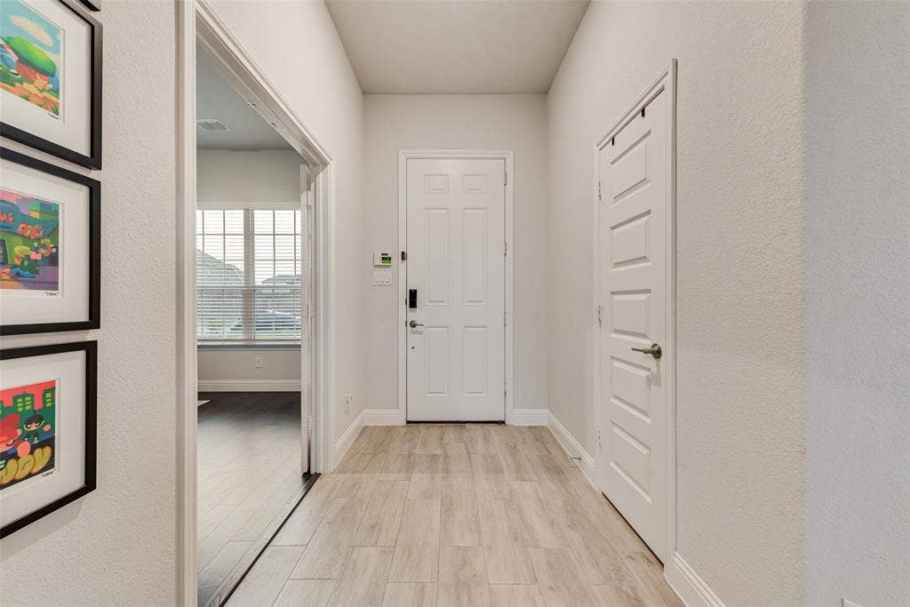 812 Stamford Avenue, Arlington, TX 76002 Entryway featuring wood-finish flooring, white paneled doors, and light-toned walls