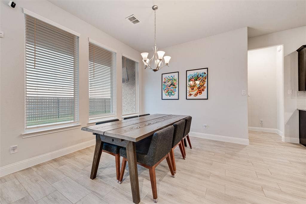812 Stamford Avenue, Arlington, TX 76002 Recessed lighting, wood-finish flooring, and multiple windows with horizontal blinds