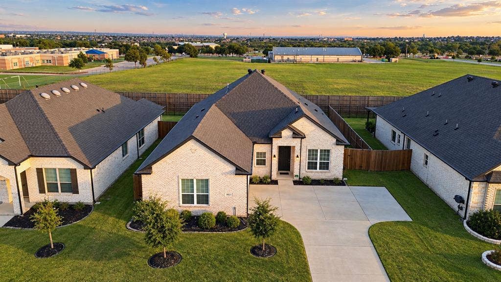 812 Stamford Avenue, Arlington, TX 76002 Light brick exterior with dark trim and a dark asphalt shingle roof