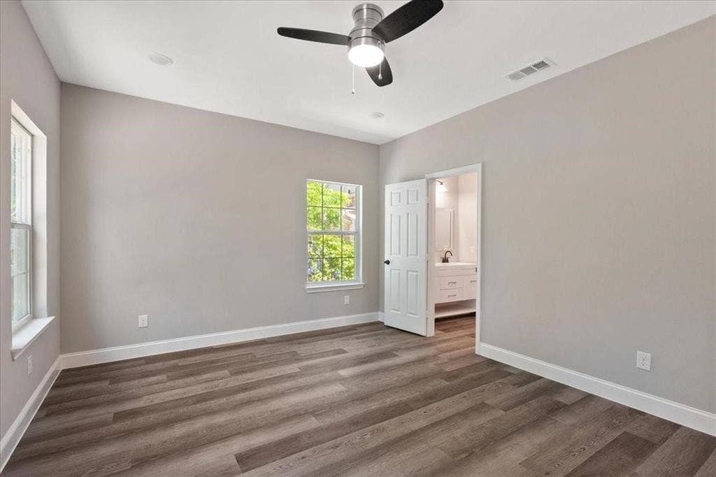 7919 N kiska Street, Dallas, TX 75216 Wood-finish flooring, two windows, ceiling fan, recessed lighting, and a white interior door