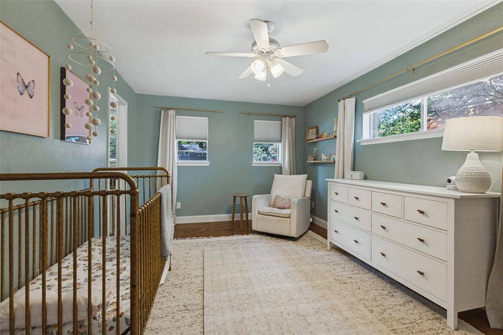 9864 Shoreview Road, Dallas, TX 75238 Wood-finish flooring, crown molding, and a ceiling fan with integrated lighting