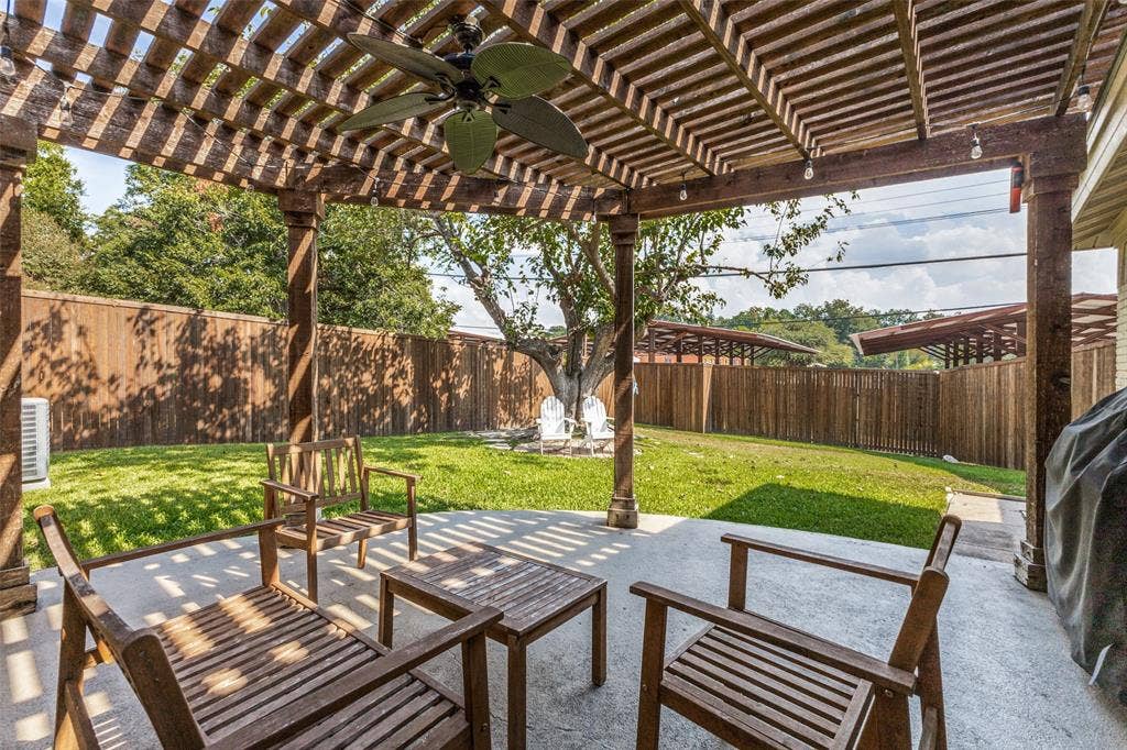 9864 Shoreview Road, Dallas, TX 75238 Expansive outdoor patio with a wooden pergola, ceiling fan, and string lighting
