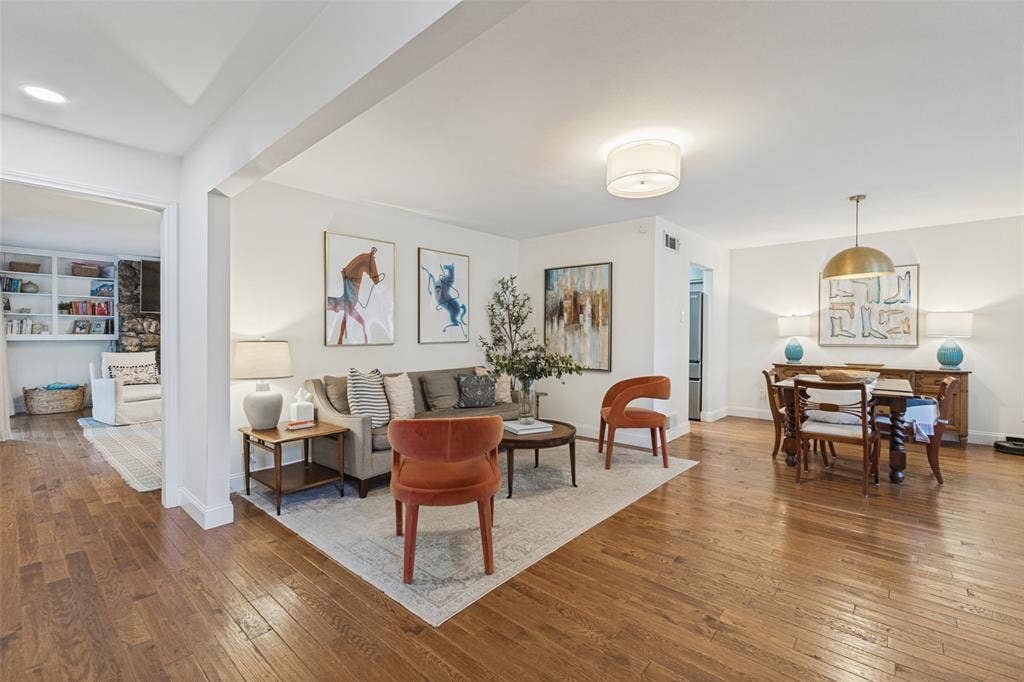 9864 Shoreview Road, Dallas, TX 75238 Hardwood flooring throughout, recessed lighting, built-in shelving, and a decorative fireplace