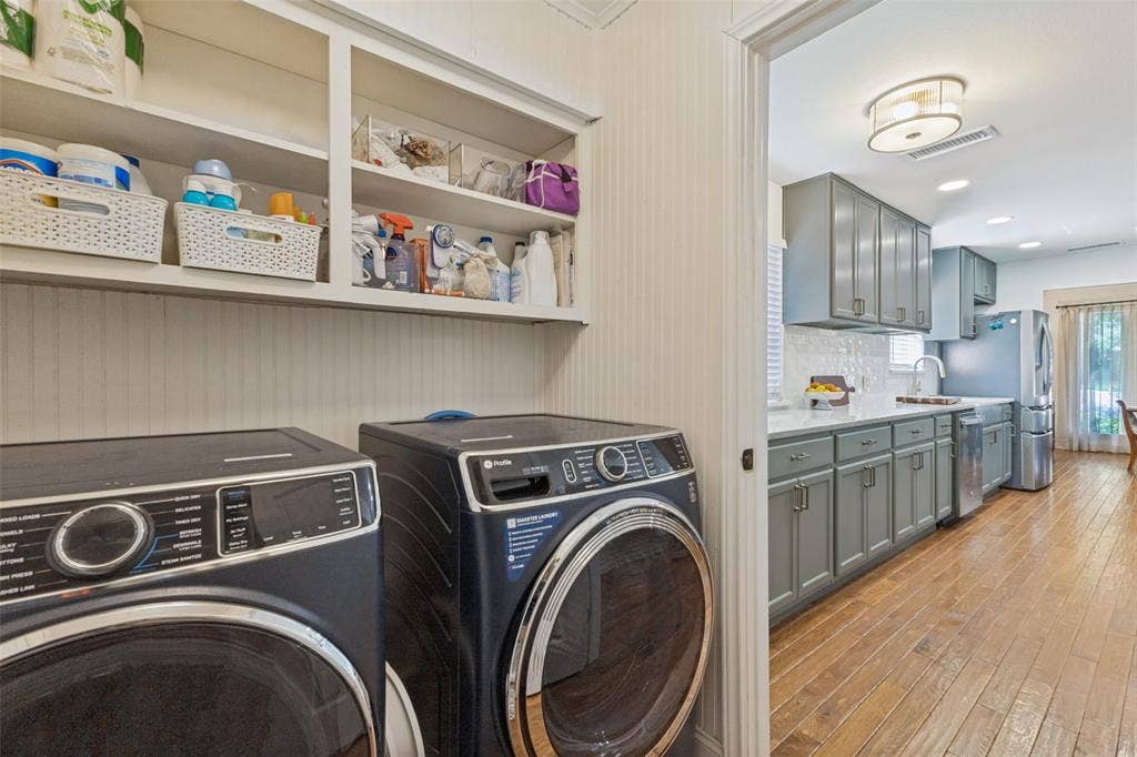 9864 Shoreview Road, Dallas, TX 75238 Built-in shelving, paneled walls, wood-finish flooring, recessed lighting, and gray cabinetry with hardware