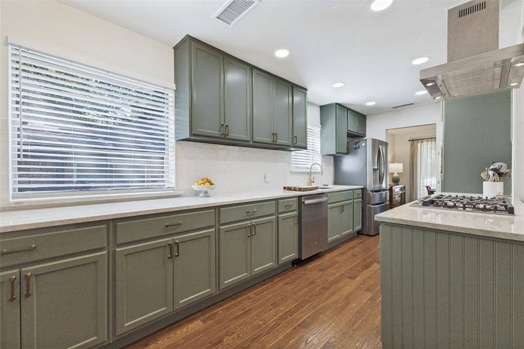 9864 Shoreview Road, Dallas, TX 75238 Kitchen featuring sage cabinetry, wood-finish flooring, recessed lighting, white countertops, and stainless steel appliances