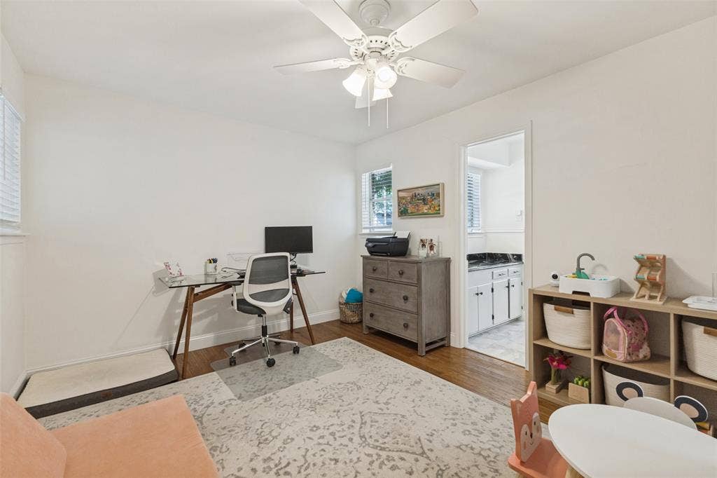 9864 Shoreview Road, Dallas, TX 75238 Hardwood-finish flooring, ceiling fan with integrated lighting, and multiple windows with blinds