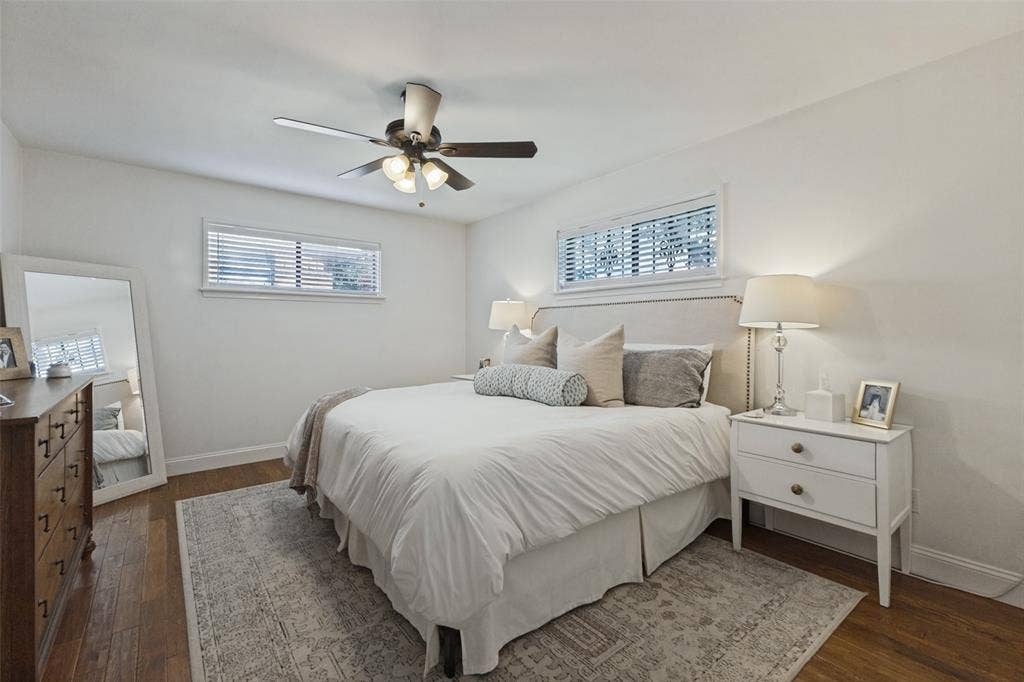 9864 Shoreview Road, Dallas, TX 75238 Wood-finish flooring with white walls and trim
