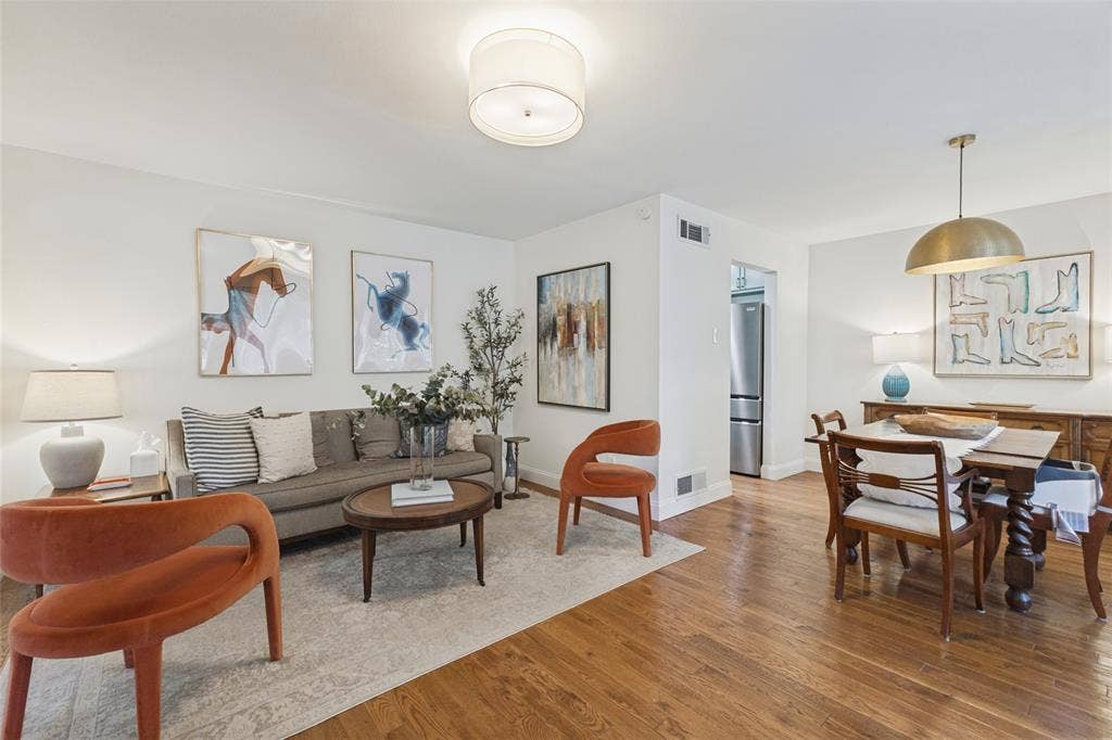 9864 Shoreview Road, Dallas, TX 75238 Hardwood flooring throughout, recessed lighting in the living area, and a dining area with a brass pendant light fixture