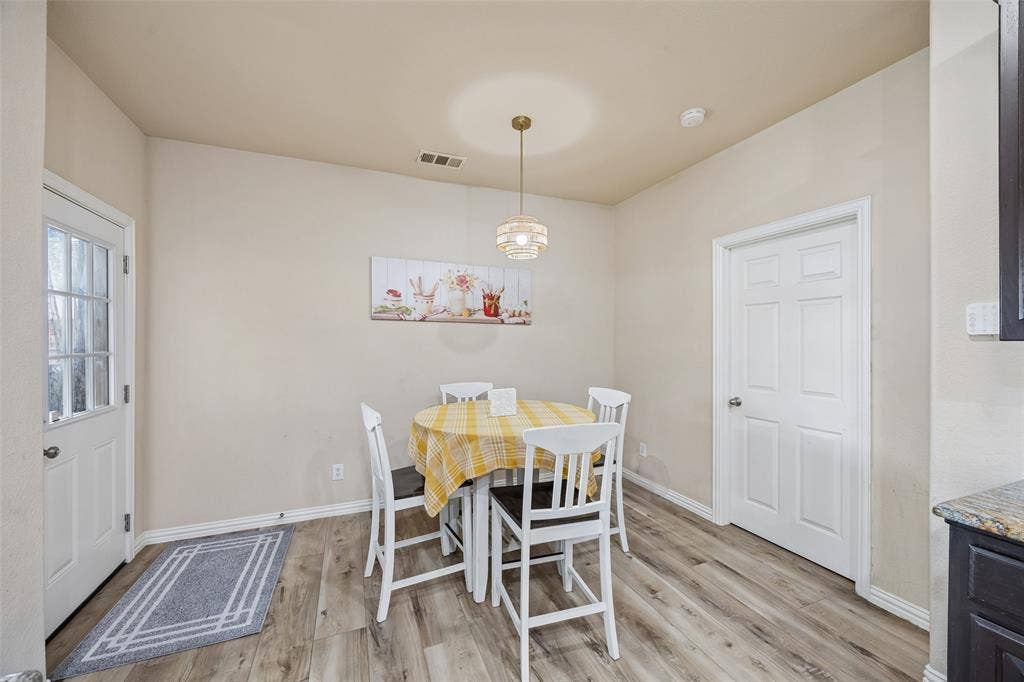 2865 Ridge View Road, Frisco, TX 75034 Wood-finish flooring throughout, with a paneled door featuring a window, and a white paneled interior door