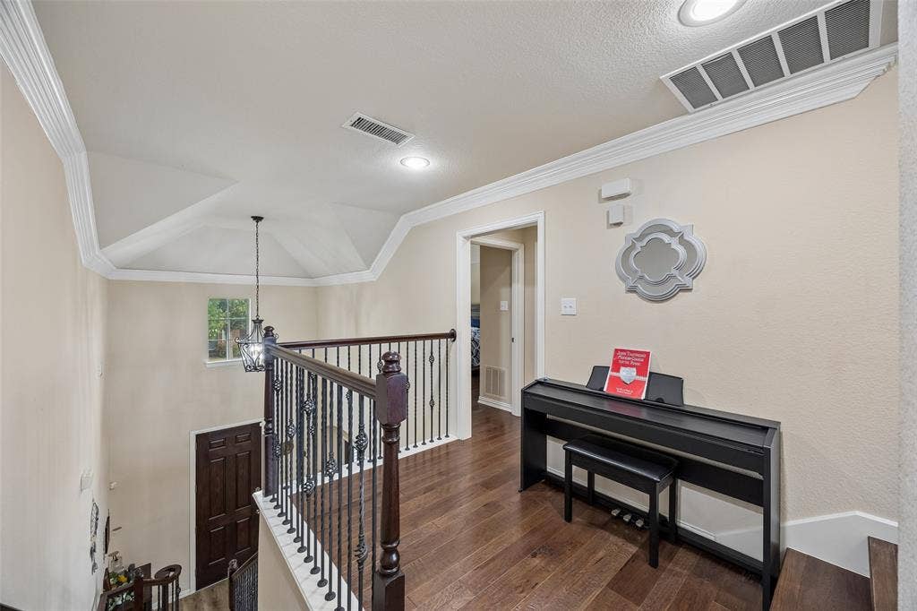 2865 Ridge View Road, Frisco, TX 75034 Wood-finish flooring, recessed lighting, crown molding, iron balusters, and a vaulted ceiling