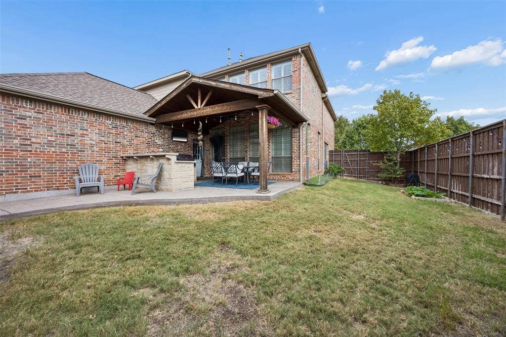 2865 Ridge View Road, Frisco, TX 75034 Brick exterior, covered patio, outdoor kitchen area, fenced yard, and concrete patio