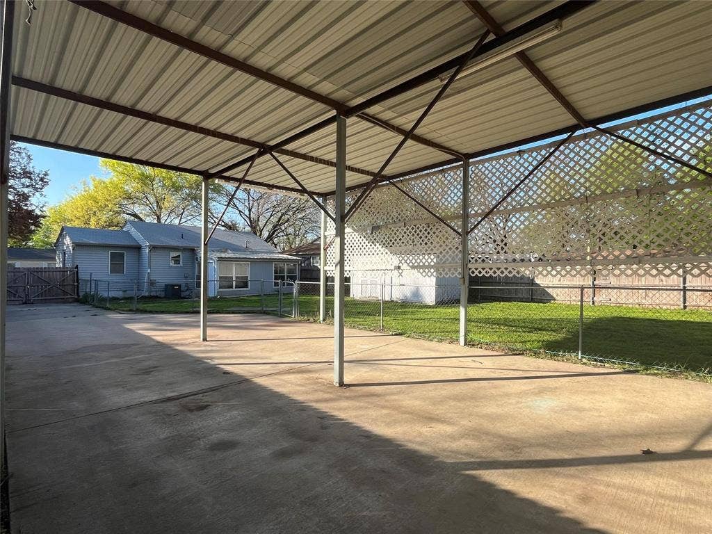 Expansive concrete patio with a covered metal roof structure